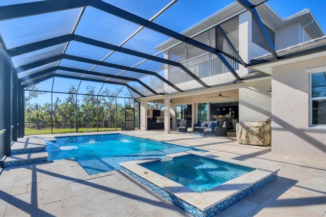 view of swimming pool featuring ceiling fan, an outdoor living space, pool water feature, a patio area, and an in ground hot tub