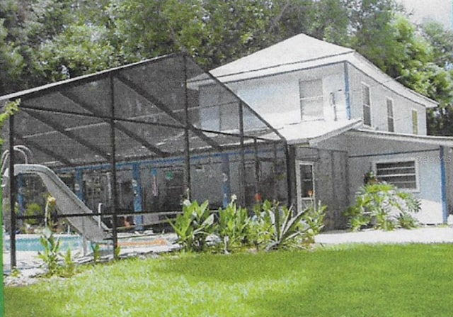 exterior space with a front lawn and a lanai