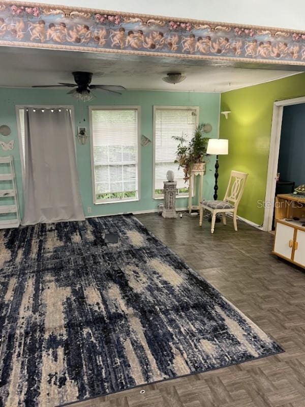 interior space featuring dark parquet floors and ceiling fan