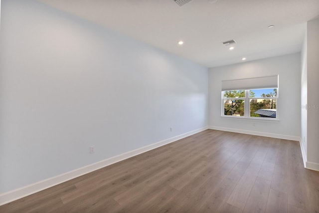 unfurnished room with hardwood / wood-style flooring