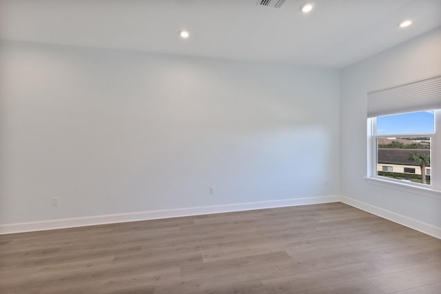 unfurnished room with light hardwood / wood-style floors