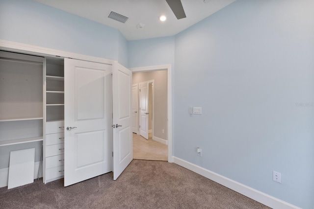 unfurnished bedroom featuring carpet, a closet, and ceiling fan