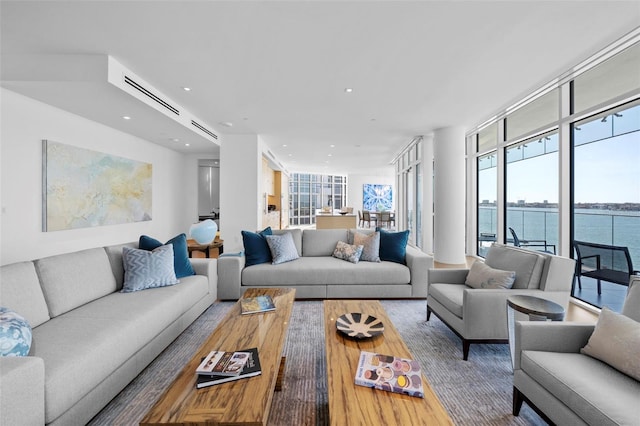 living room featuring a water view and hardwood / wood-style flooring