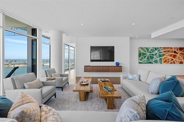 living room with a water view and light hardwood / wood-style flooring