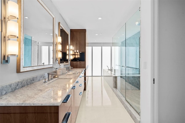 bathroom featuring tile patterned flooring, vanity, and walk in shower