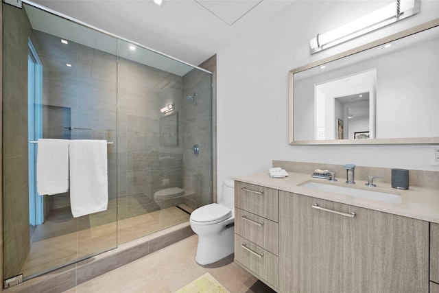 bathroom featuring tile patterned floors, vanity, toilet, and an enclosed shower