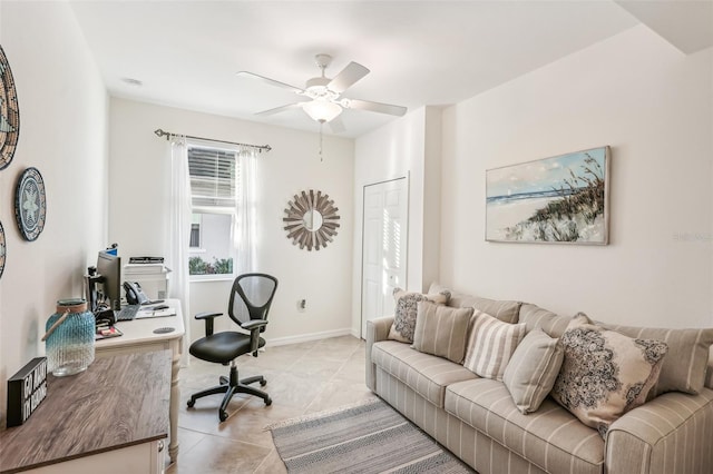 office featuring light tile patterned floors, ceiling fan, and baseboards