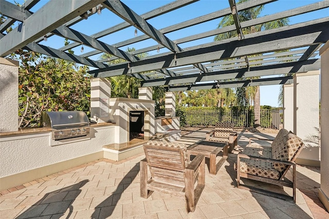 view of patio / terrace featuring area for grilling, a pergola, and an outdoor kitchen