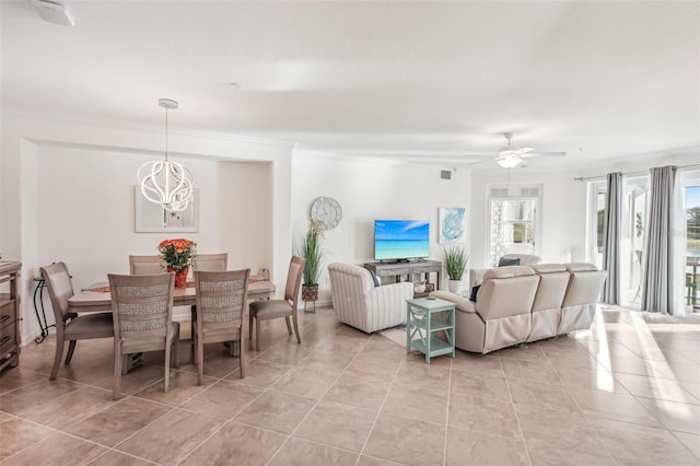 tiled living room featuring crown molding and ceiling fan with notable chandelier