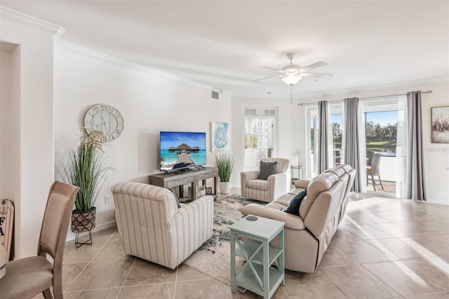 living room with light tile patterned floors, ornamental molding, visible vents, and a ceiling fan