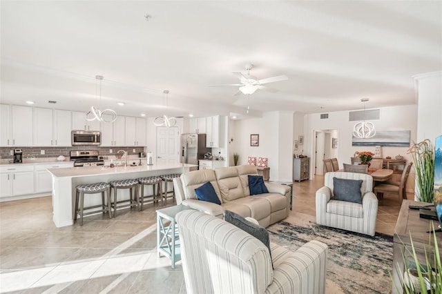 living area featuring light tile patterned floors, ceiling fan, and visible vents