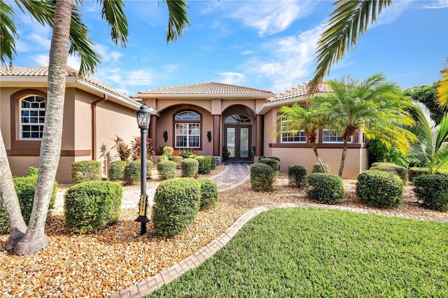 mediterranean / spanish-style home with a front lawn