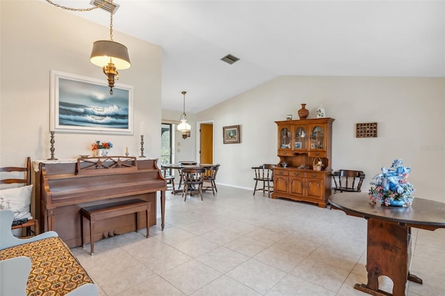 miscellaneous room featuring light tile patterned floors and lofted ceiling