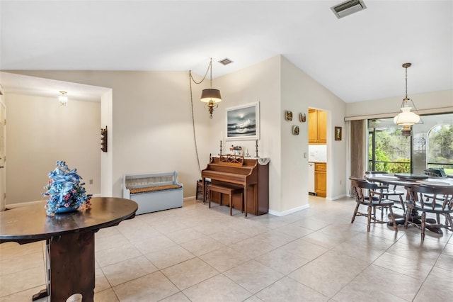 tiled dining room with vaulted ceiling