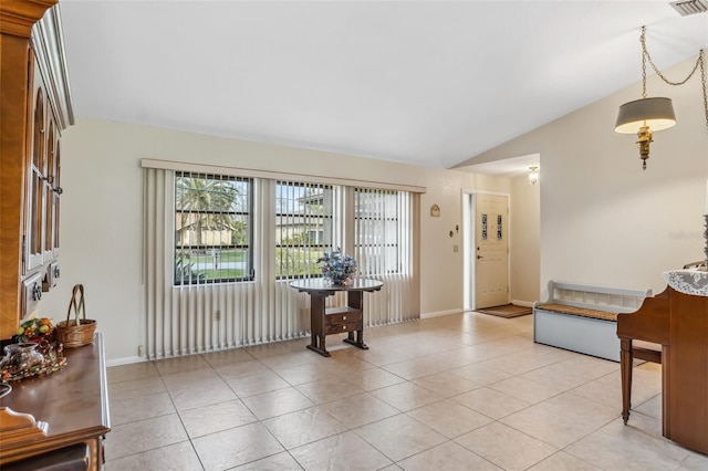 foyer entrance featuring light tile patterned floors and lofted ceiling