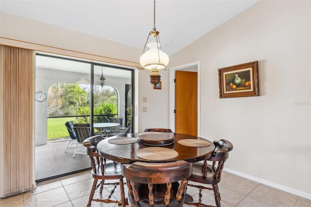 dining room featuring light tile patterned floors and lofted ceiling