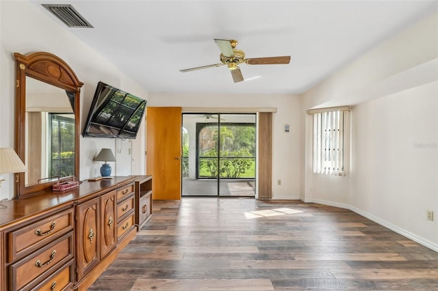 living room with ceiling fan and dark wood-type flooring