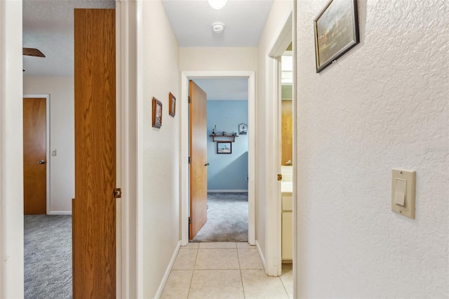 corridor featuring light colored carpet