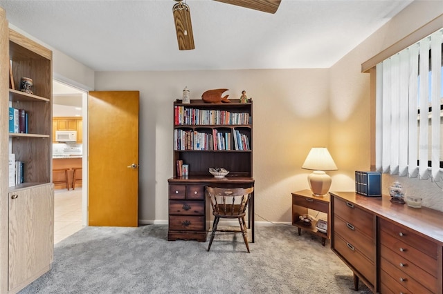 carpeted office featuring ceiling fan