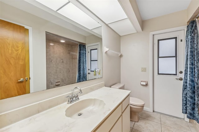 bathroom featuring toilet, tile patterned floors, and vanity