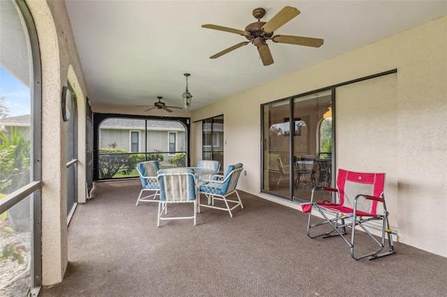 sunroom featuring ceiling fan and a wealth of natural light