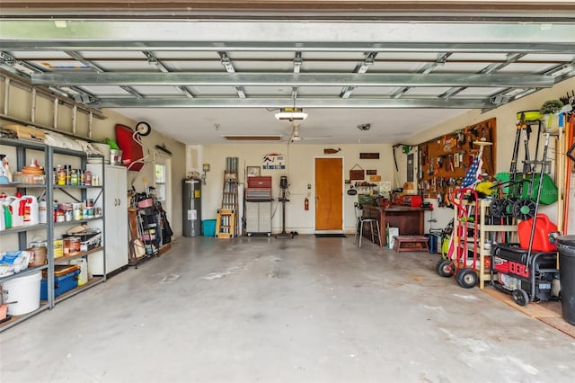 garage featuring a workshop area, water heater, and a garage door opener