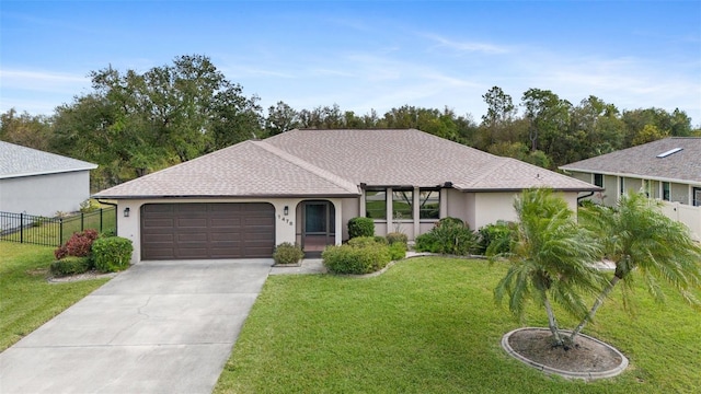 ranch-style house with a garage and a front lawn