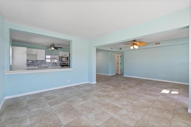 unfurnished living room with ceiling fan