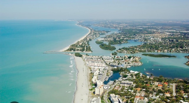 drone / aerial view featuring a water view and a view of the beach