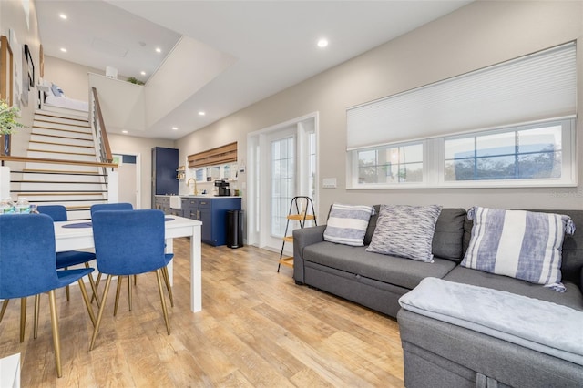 living room with sink and light wood-type flooring