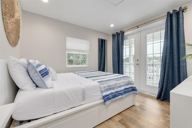 bedroom featuring access to exterior and light hardwood / wood-style flooring