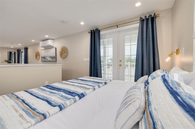 bedroom with a wall mounted air conditioner, access to outside, and french doors