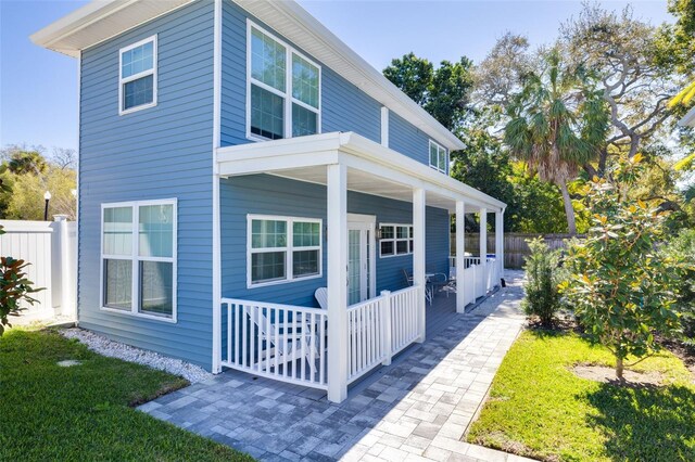 719 Douglas Ave, Dunedin, FL 34698 - view of side of home featuring covered porch