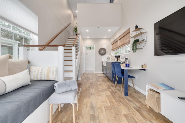 living room with sink and light hardwood / wood-style floors