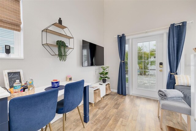 719 Douglas Ave, Dunedin, FL 34698 - office with light wood-style flooring, a high ceiling, and baseboards