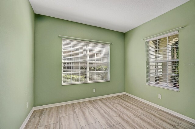 unfurnished room with a textured ceiling