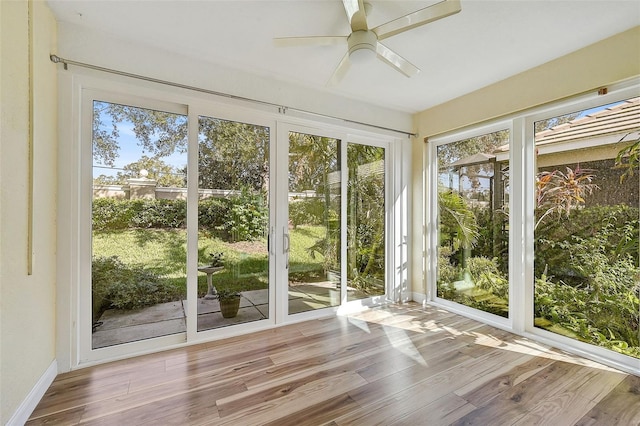 unfurnished sunroom featuring ceiling fan