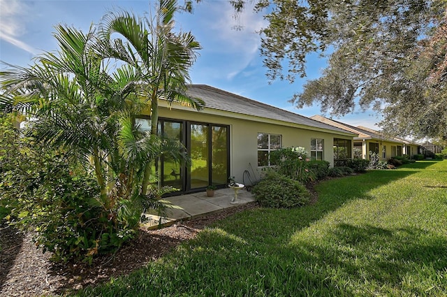 rear view of property with a yard