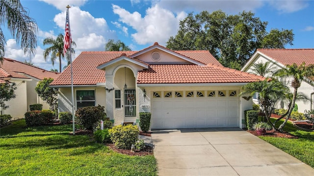 mediterranean / spanish house featuring a garage and a front lawn