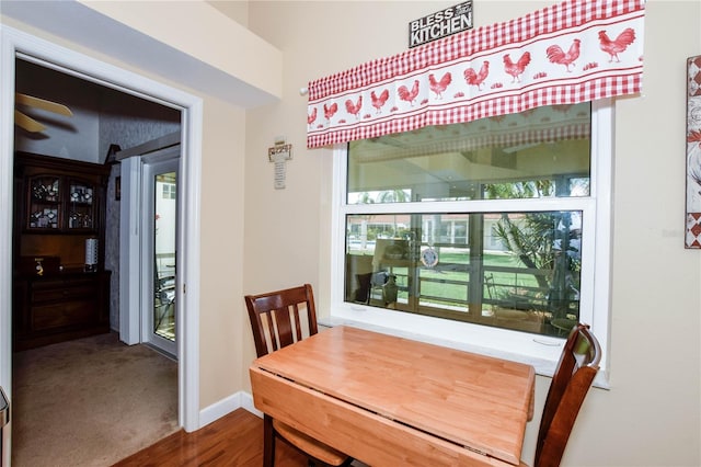 dining space with wood-type flooring