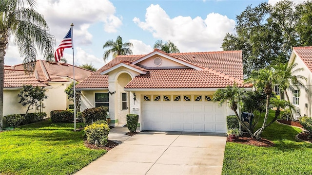 mediterranean / spanish home with a garage and a front yard