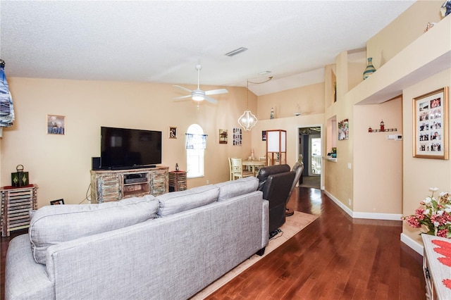 living room featuring lofted ceiling, dark hardwood / wood-style floors, a textured ceiling, and ceiling fan