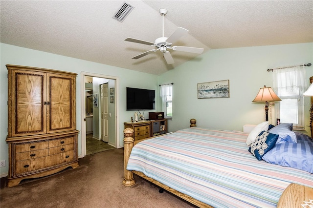 carpeted bedroom featuring ceiling fan, lofted ceiling, multiple windows, and a textured ceiling