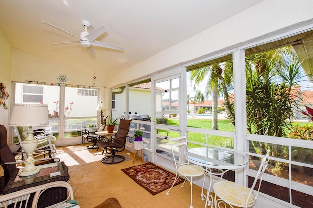 sunroom featuring vaulted ceiling and ceiling fan