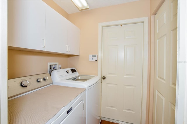 laundry area featuring cabinets and washing machine and clothes dryer