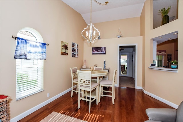 dining area featuring dark hardwood / wood-style floors, high vaulted ceiling, and a notable chandelier