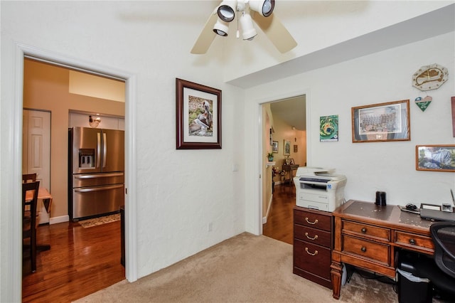 carpeted office featuring ceiling fan