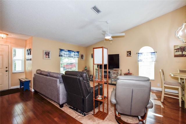 living area with lofted ceiling, baseboards, visible vents, and dark wood finished floors