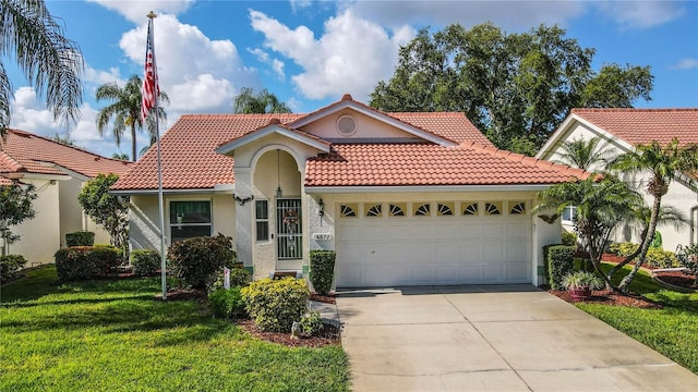 mediterranean / spanish-style house with a garage, a tiled roof, a front lawn, and stucco siding