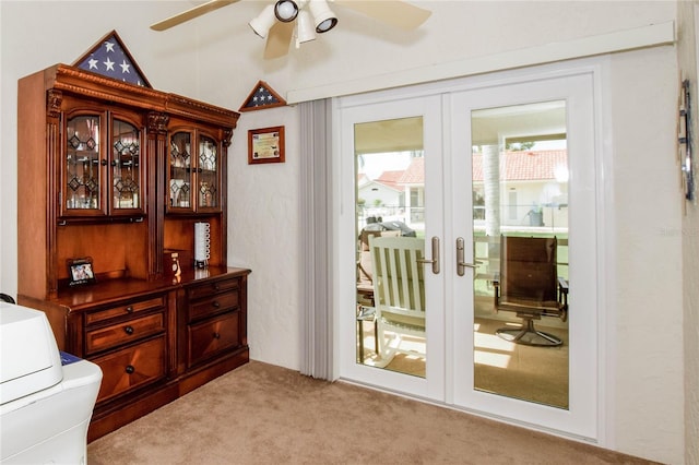 doorway with a ceiling fan, french doors, and light carpet